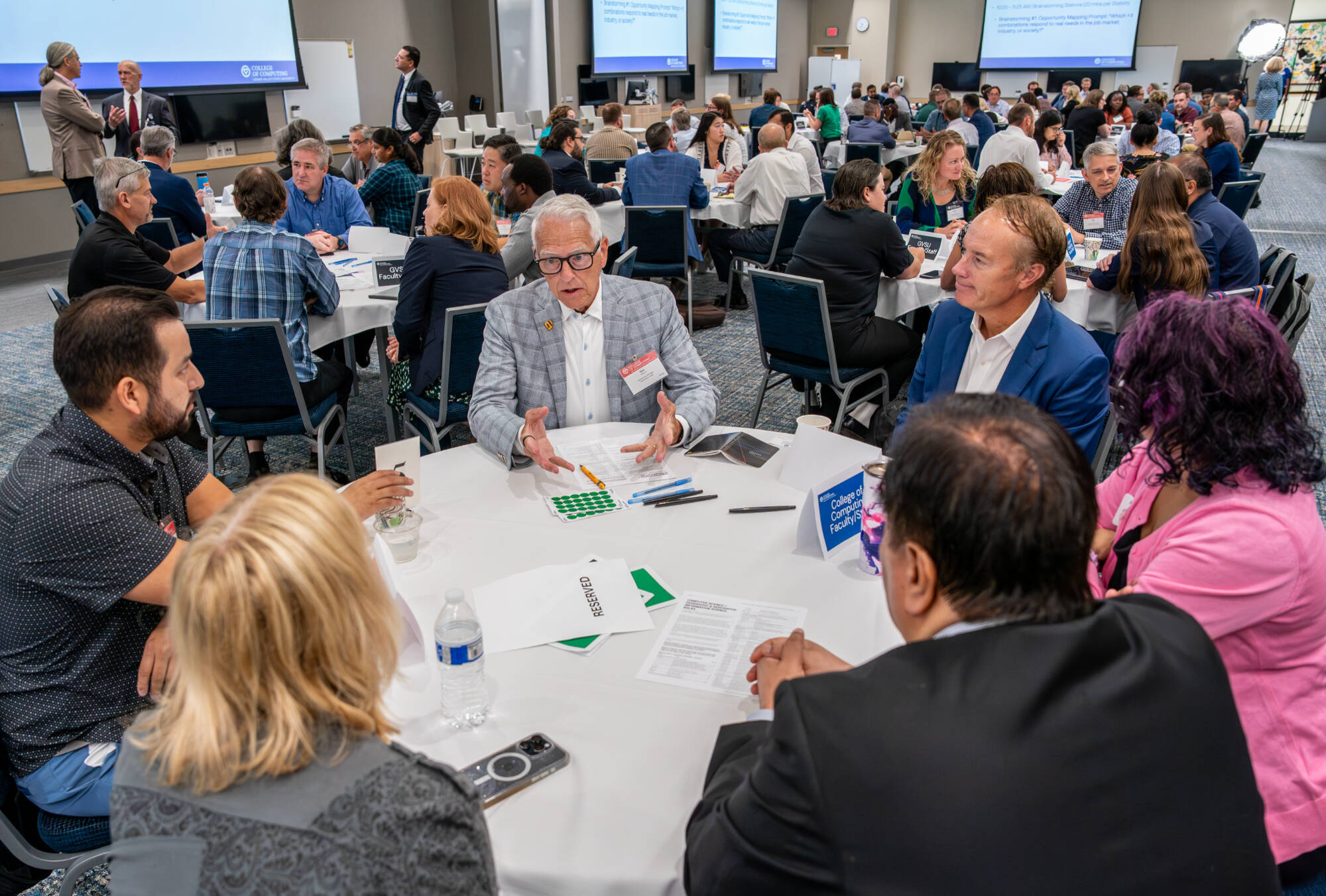 Participants, including Dan Stewart, center, a relationship manager for Automation Alley, take part in a College of Computing brainstorming session at the DeVos Center for Interprofessional Health on August 7.